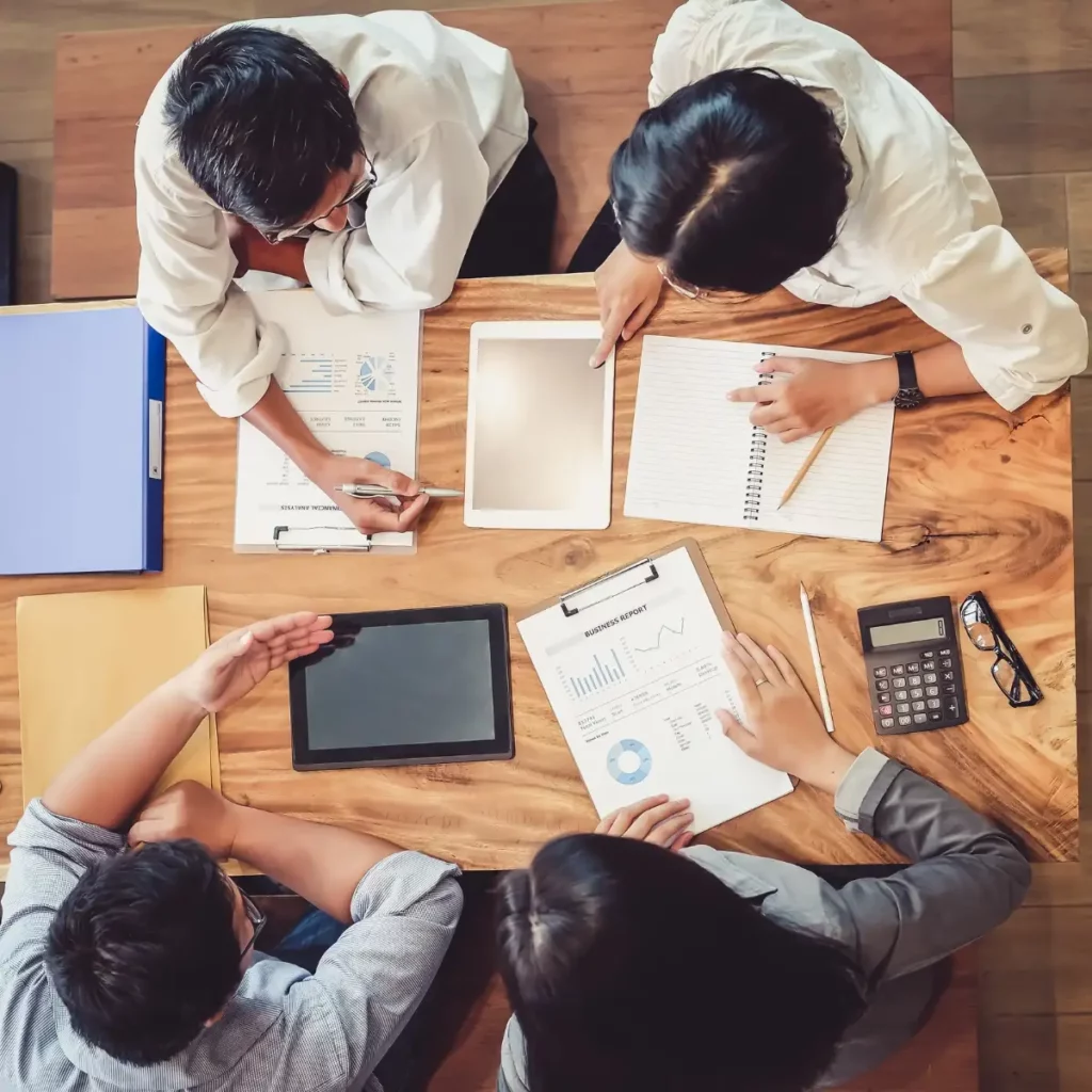 birdseye view of people at desk making notes