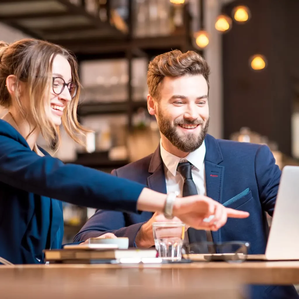 people pointing at laptop