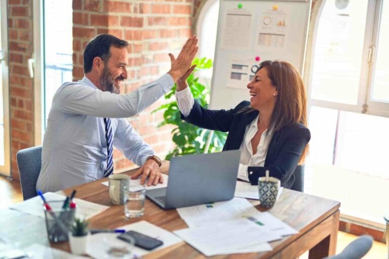 people who work together hi fiving