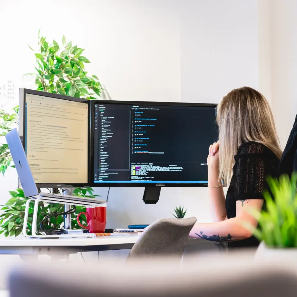 developer Rach working at desk with code open on screen