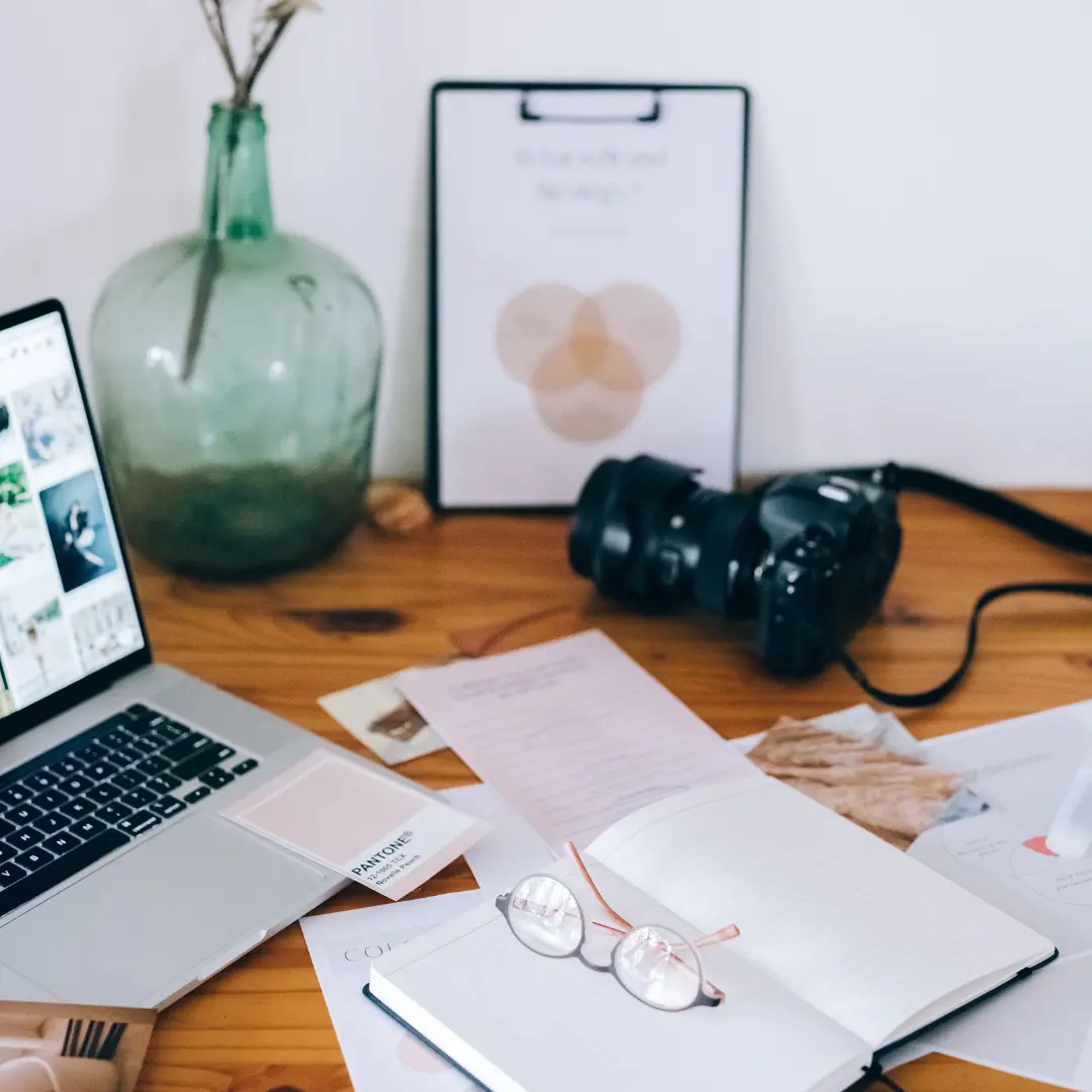 branding material with a laptop open and a camera