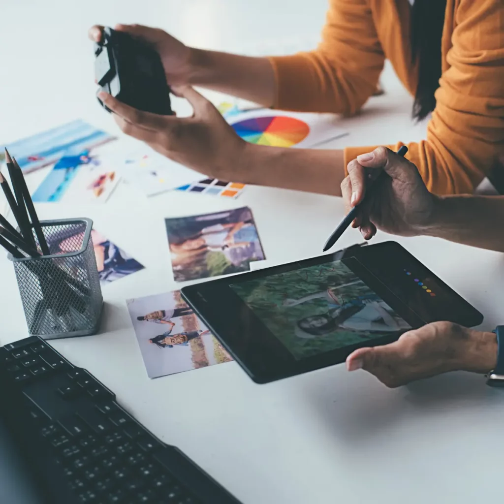 person looking at a camera and person looking at a tablet with the photo on