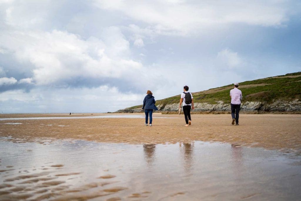 people walking along a beach