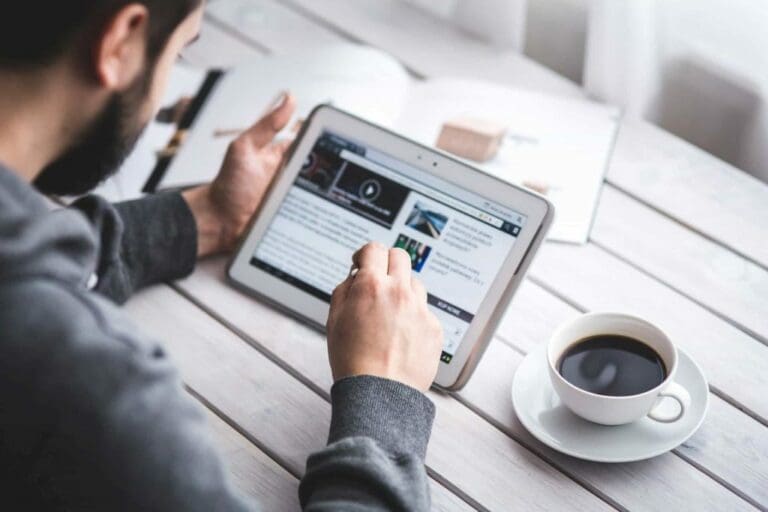 man looking at a minimum viable product on tablet