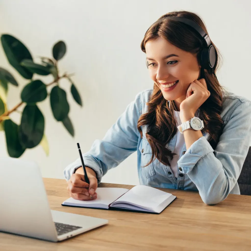 person attending a webinar and taking notes