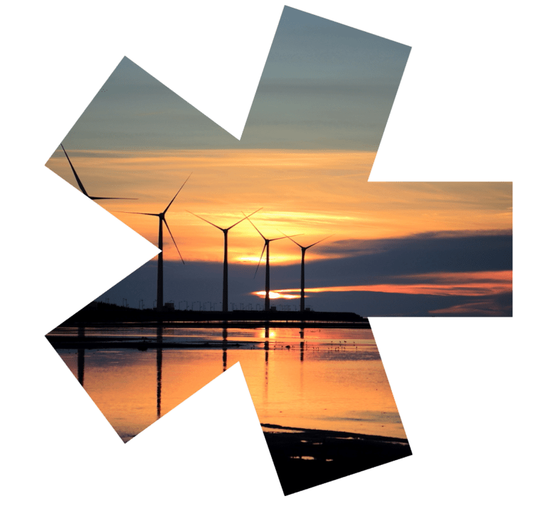 A photo of wind turbines by the water at sunset, in the Hiyield asterisks.