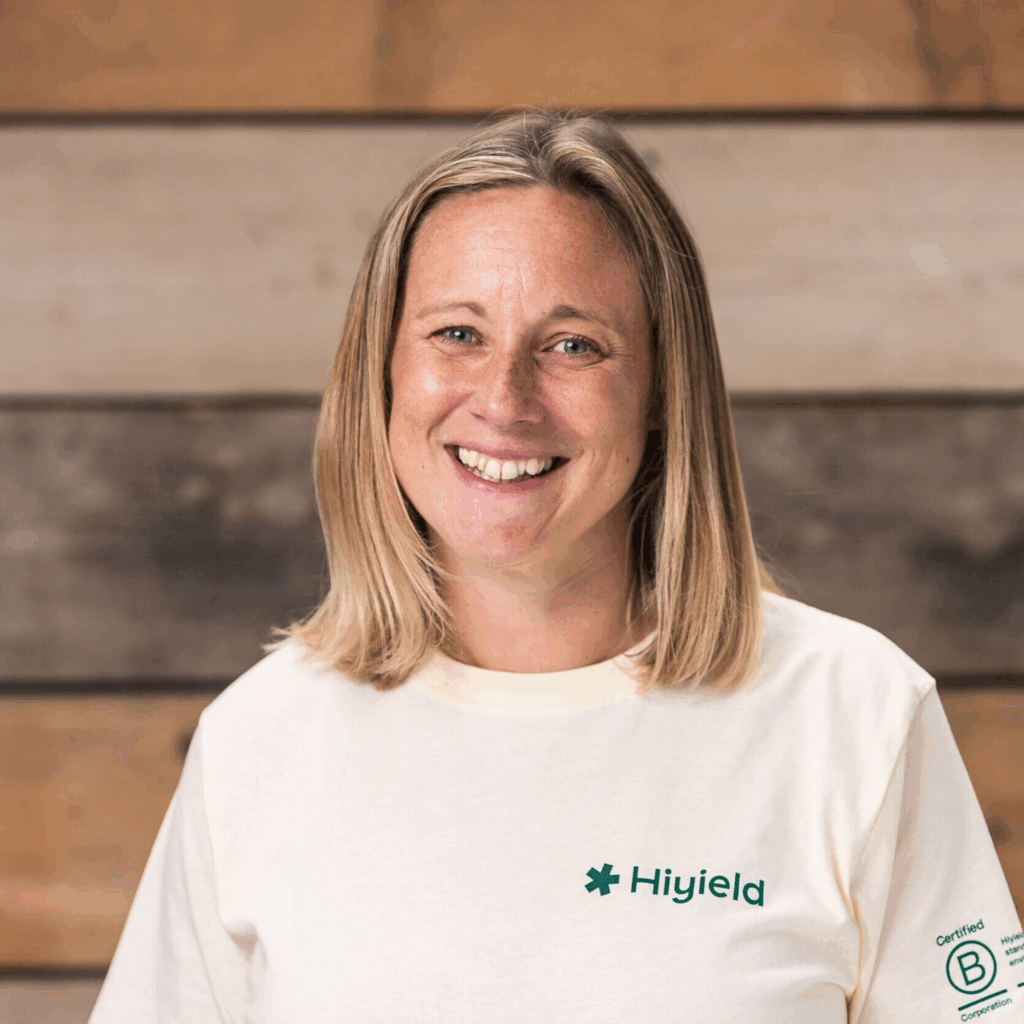 Laura Hudspith wearing a cream Hiyield B Corp t-shirt and smiling.