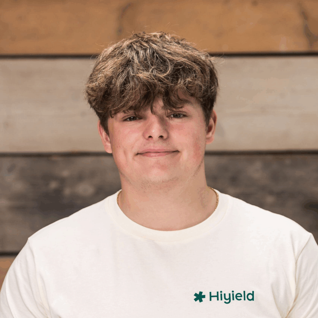 Alfie Phillips (full stack software development apprentice) wearing a cream Hiyield t-shirt.