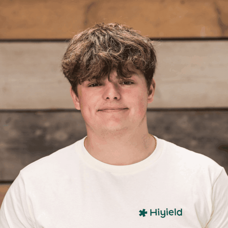 Alfie Phillips (full stack software development apprentice) wearing a cream Hiyield t-shirt.
