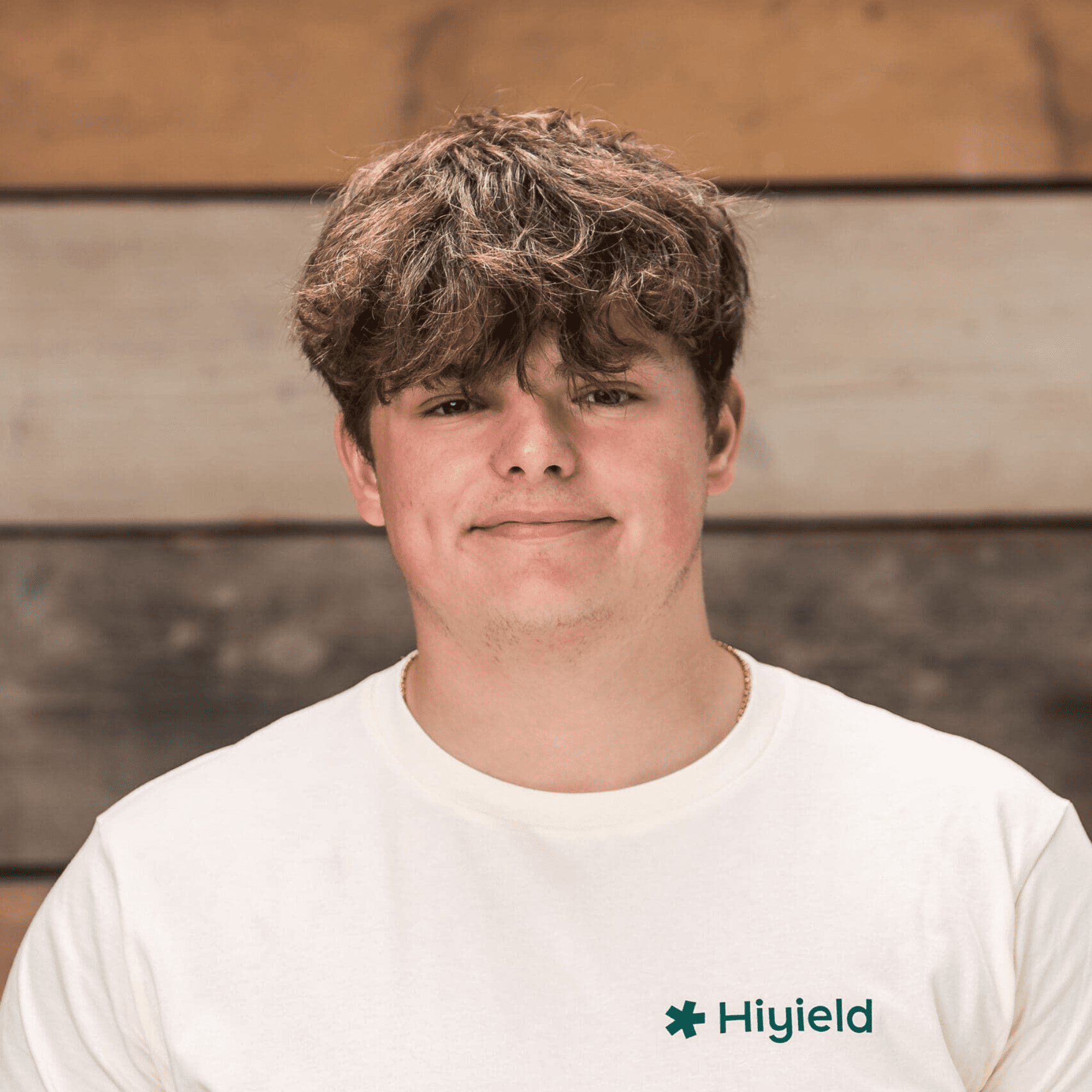 Alfie Phillips (full stack software development apprentice) wearing a cream Hiyield t-shirt.