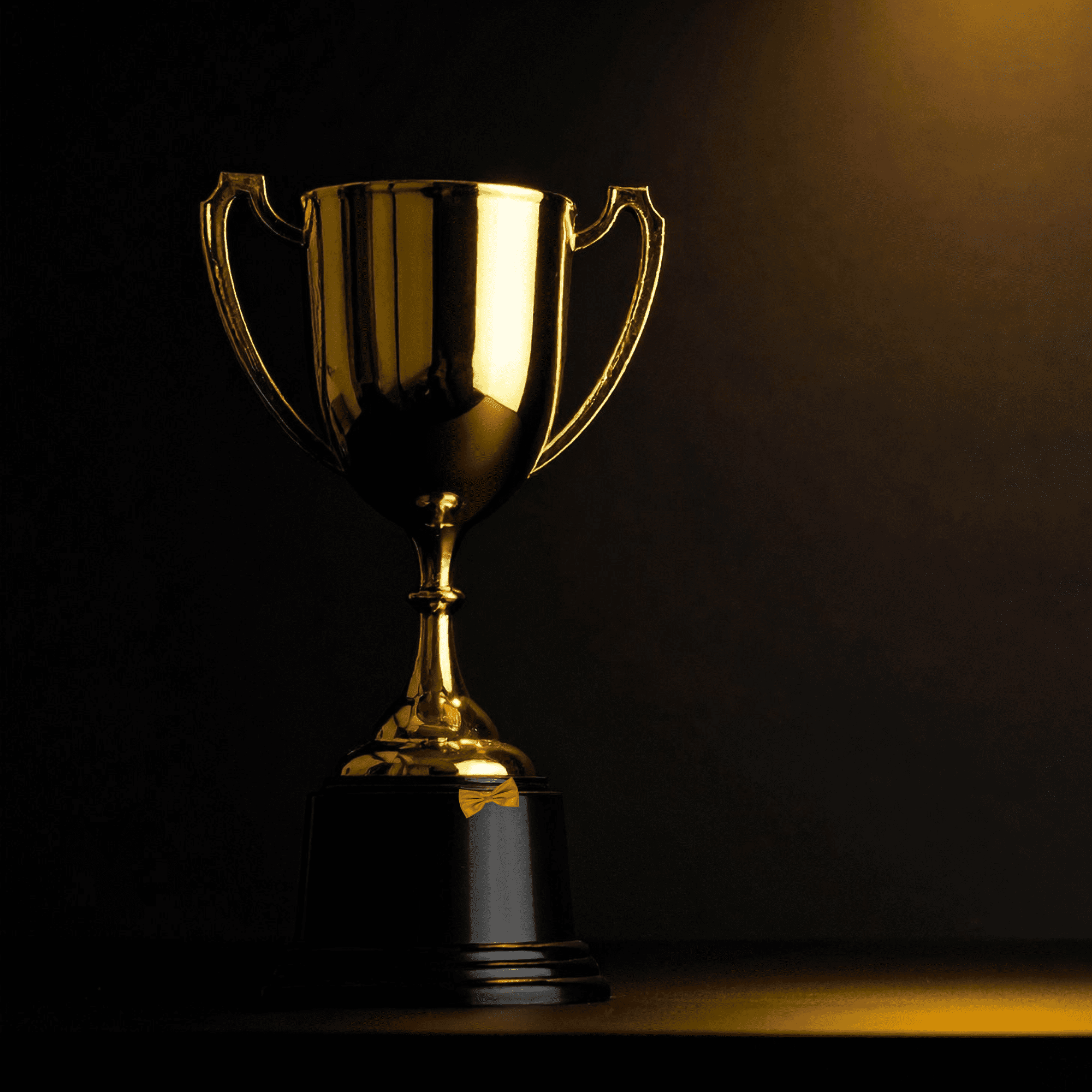 Gold Trophy with gold bow tie.
