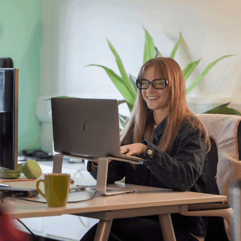 Sophie smiling at her desk in the Hiyield office.