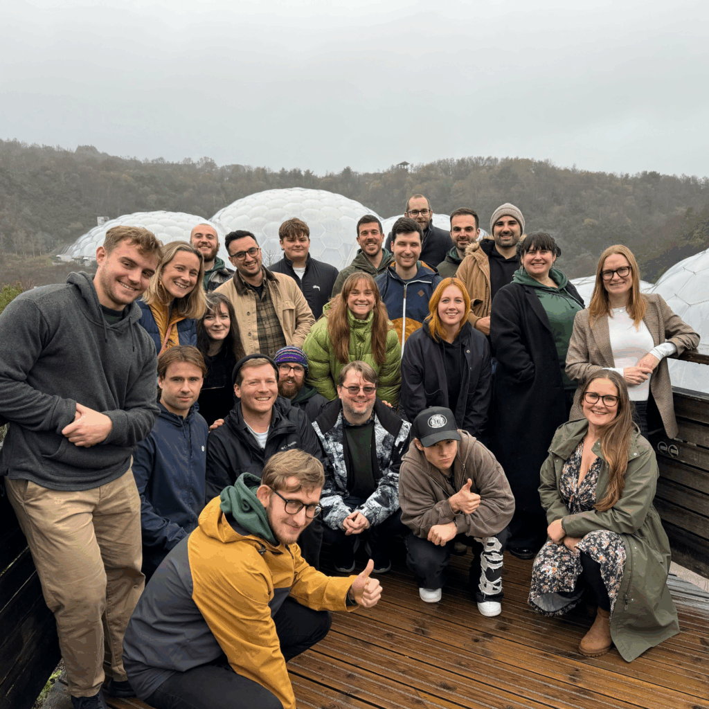 The Hiyield (B Corp) team posing in front of the Eden Project biomes.