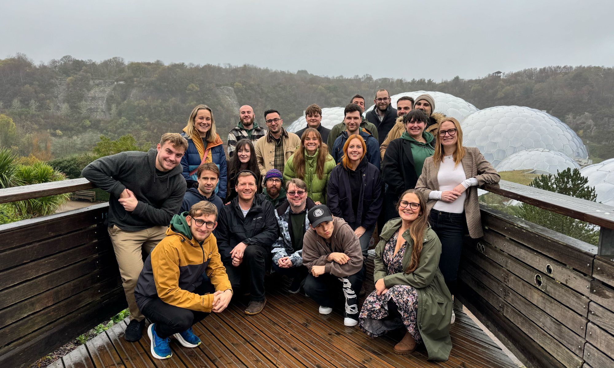 The Hiyield team posing for the camera on the viewing platform in front of the Eden Project Biomes.