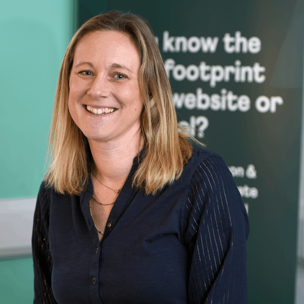 Laura Hudspith smiling in front of a Hiyield roll up banner.