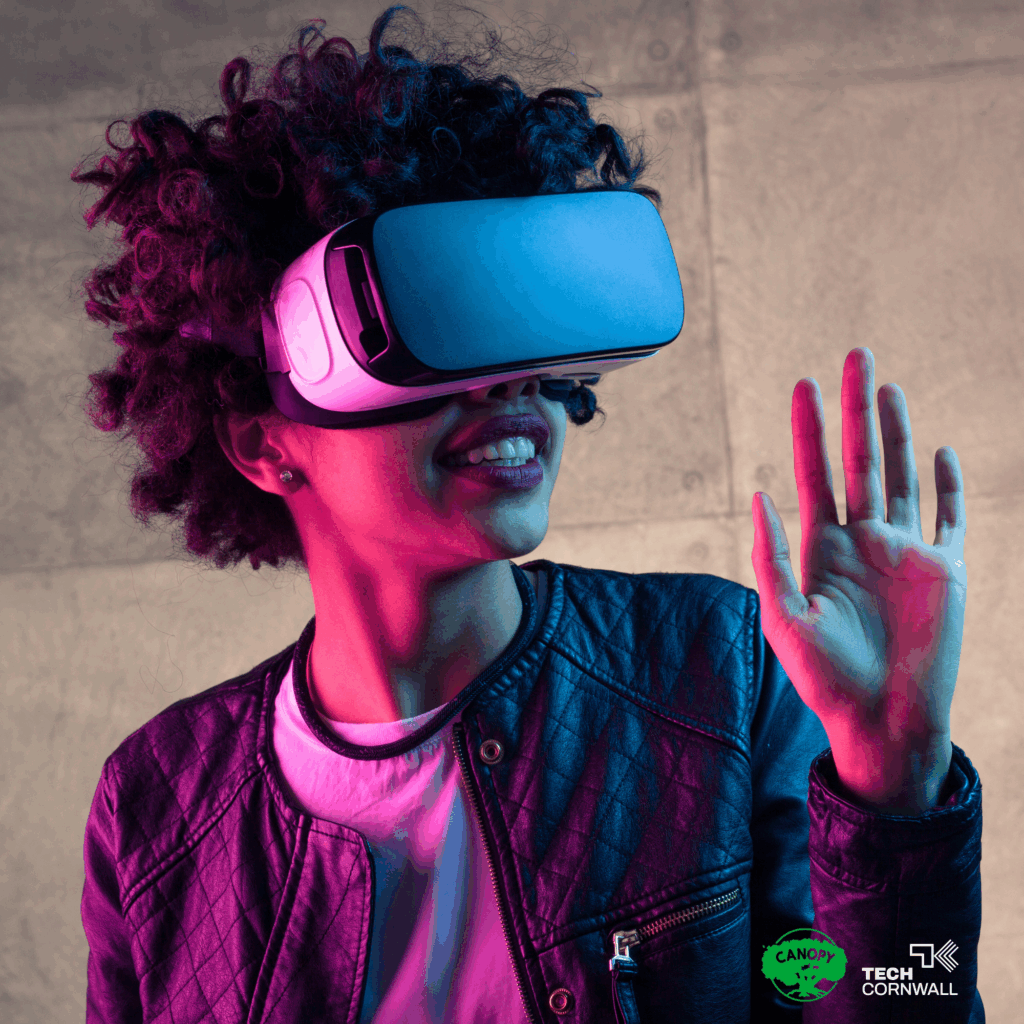 A woman demoing VR lit with pink and blue lights.