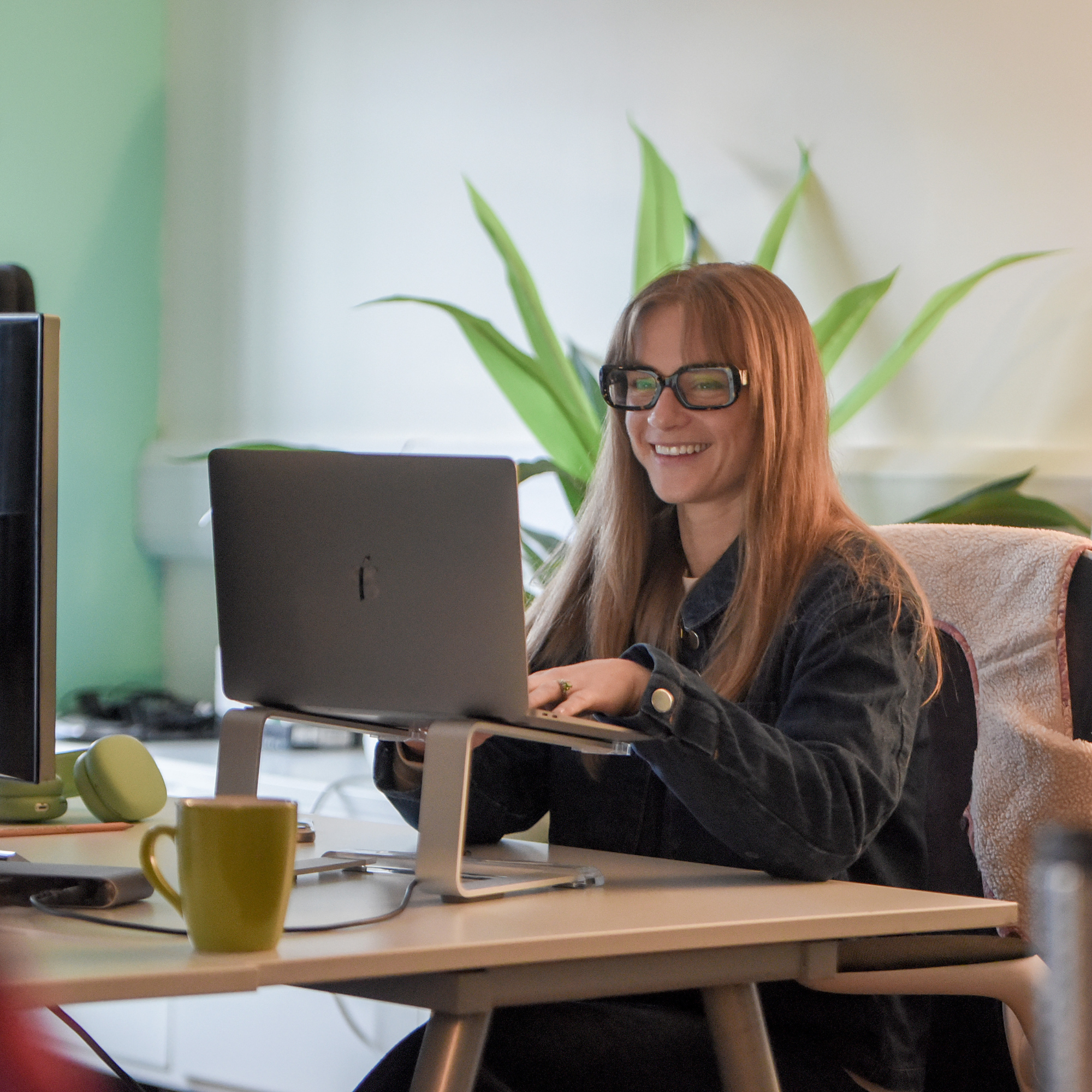 Sophie in the Hiyield office using her laptop.